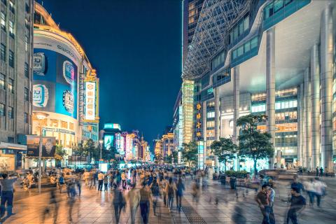 Nanjing Road shopping street in Shanghai, China – bustling pedestrian walkway with bright lights and modern skyscrapers.
