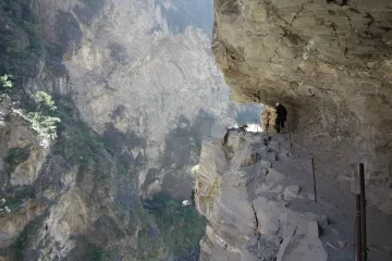  Solo trekker navigating the switchbacks of Tiger Leaping Gorge, a legendary adventure trail in southwest China.